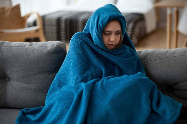Ilustrasi seorang perempuan kedinginan menggunakan selimut. Foto: Pixabay