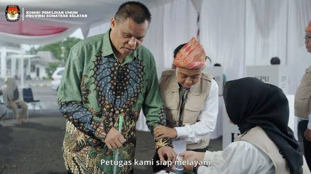 Ilustrasi menunjukkan petugas pemilu membantu seorang pria yang memiliki keterbatasan fisik di tempat pemungutan suara. by Instagram KPU Provinsi Sumatera Selatan