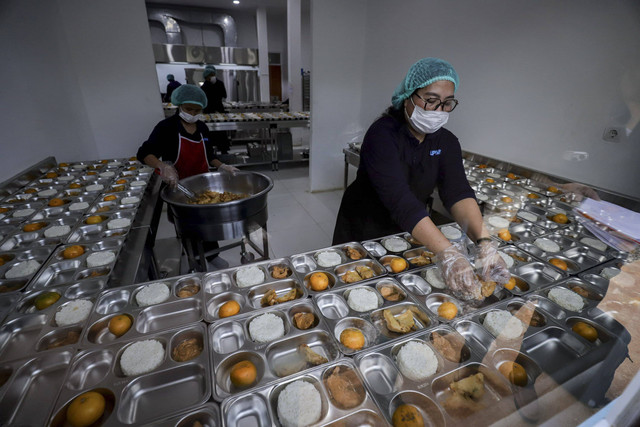 Petugas menyiapkan makanan di SPPG Jakarta Barat, Senin (6/1/2025). Foto: Jamal Ramadhan/kumparan