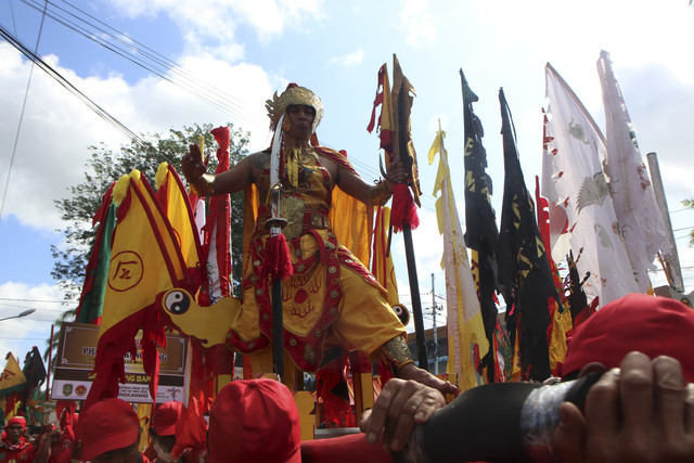 Seorang Tatung (dukun Tionghoa yang kerasukan arwah leluhur) beratraksi di atas tandu saat mengikuti pawai Perayaan Cap Go Meh 2025 di Kota Singkawang, Kalimantan Barat, Rabu (12/2/2025). Foto: Jessica Wuysang/ANTARA FOTO