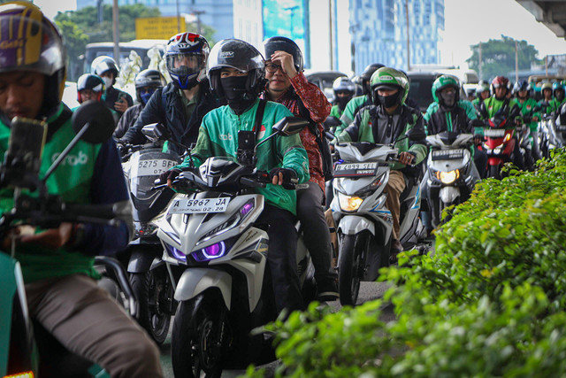 Pengemudi ojek online (ojol) menunggu datangnya penumpang di Halte LRT Pancoran, Jakarta, Rabu (12/3/2025). Foto: Iqbal Firdaus/kumparan