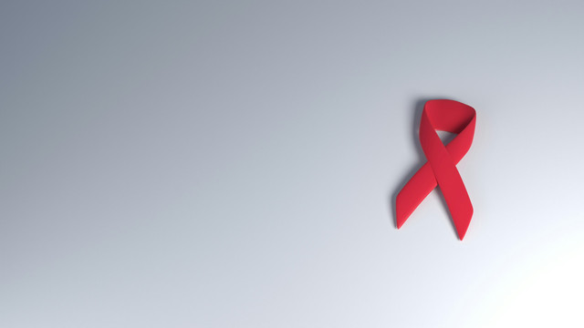 Gambar oleh Ubaid E. Alyafizi dari Unsplash (https://unsplash.com/photos/a-red-ribbon-on-a-white-background-sbu3lTahl-o) — Simbol pita merah sebagai bentuk kepedulian dan kesadaran terhadap HIV/AIDS. 