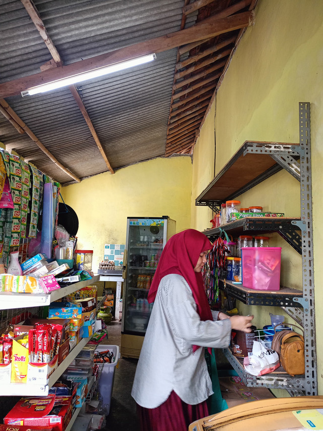 perempuan pelaku UMKM tengah beraktivitas di toko kelontongnya, menunjukan peran aktif perempuan dalam mendukung ekonomi keluarga dan masyarakat. foto: Siti Nur Hikmah/ Koperasi al Qosimiyyah