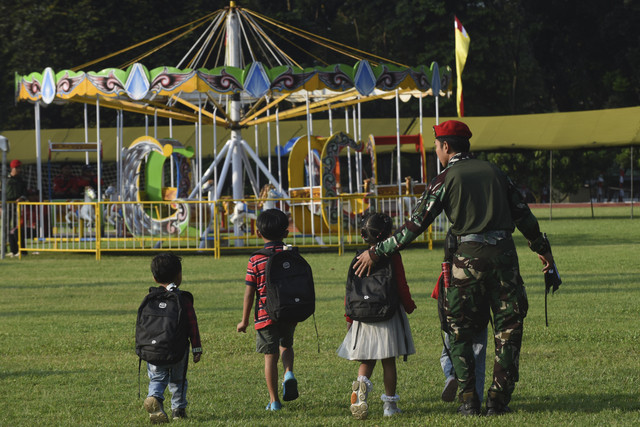 Anak-anak bermain wahana permainan pada acara Hari Gembira Anak Yatim dan Anak Prajurit Kopassus di Lapangan Atang Sutresna, Cijantung, Jakarta, Sabtu (26/3/2025). Foto: Indrianto Eko Suwarso/ANTARA FOTO