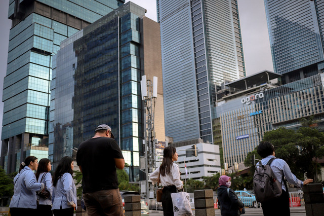 Pekerja melintasi pelican crossing saat jam pulang kerja di Kawasan Jalan Jendral Sudirman, Jakarta, Senin (5/5/2025). Foto: Jamal Ramadhan/kumparan