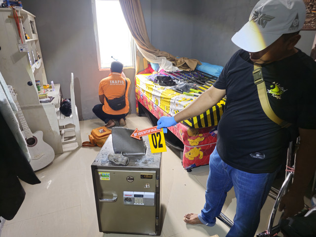 Petugas memperlihat brankas yang dirusak pelaku di TKP. Foto: Dok. Polres Bengkayang