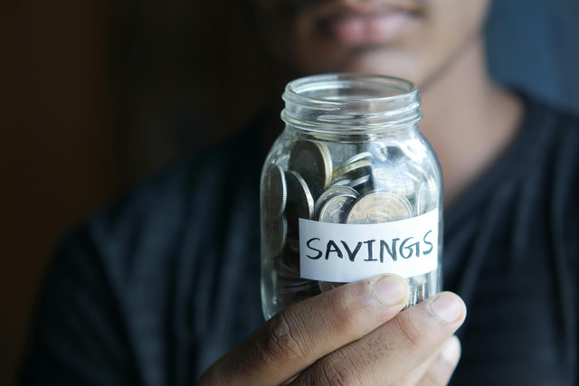 Photo by Towfiqu barbhuiya: https://www.pexels.com/photo/close-up-shot-of-a-person-holding-a-jar-with-coins-9755383/
