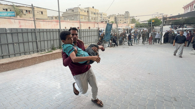 Seorang pria menggendong seorang warga Palestina yang terluka, setelah serangan udara Israel di Rumah Sakit Eropa, di Rumah Sakit Nasser di Khan Younis, di Jalur Gaza selatan, 13 Mei 2025. Foto: REUTERS/Stringer