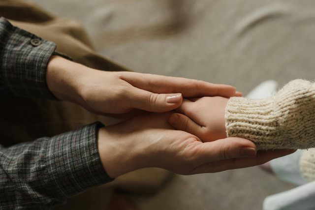 Photo by Arina Krasnikova: https://www.pexels.com/photo/close-up-shot-of-parent-holding-her-child-s-hands-6338763/