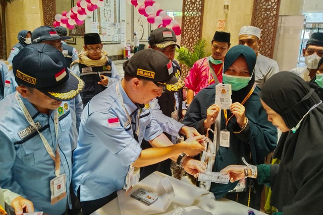 Dirjen Penyelenggaraan Haji dan Umrah Kemenag, Hilman Latief, membagikan kartu nusuk ke jemaah di Makkah. Foto: MCH 2025