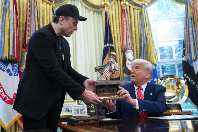 Presiden Amerika Serikat Donald Trump memberikan plakat kunci gedung putih kepada pengusaha Elon Musk saat konferensi pers di Ruang Oval Gedung Putih, Washington DC, Amerika Serikat, Jumat (30/5/2025). Foto: Allison Robbert/AFP