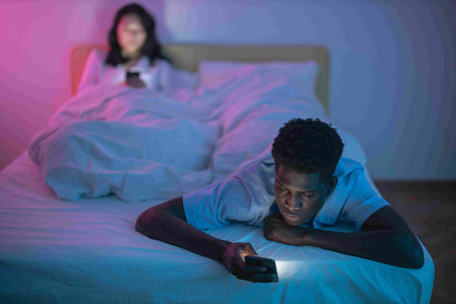 Ilustrasi bermain gadget di tempat tidur (sumber: https://www.pexels.com/id-id/foto/pria-laki-laki-lelaki-wanita-7351141/)