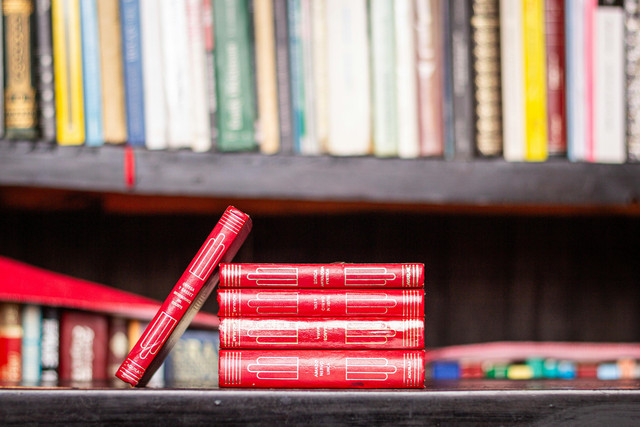 Photo by Felipe Prieto Isla: https://www.pexels.com/photo/pile-of-red-books-on-a-bookshelf-18847268/
