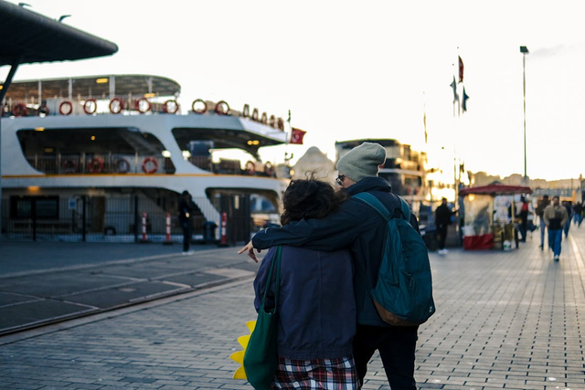 Photo by Melisa Özdemir from Pexels: https://www.pexels.com/photo/couple-strolling-in-karakoy-with-ferry-view-32572238/