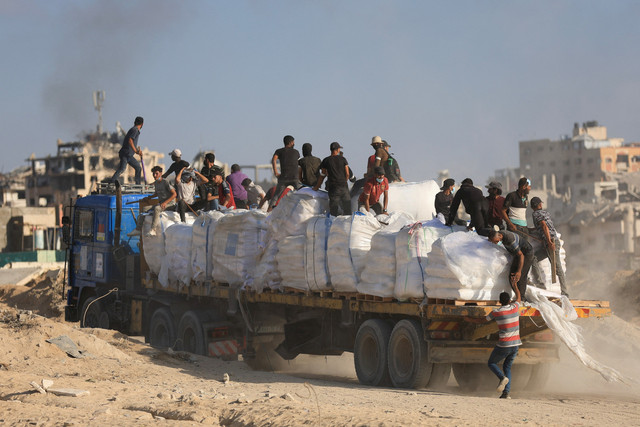 Warga Palestina truk bantuan di Beit Lahia,  Jalur Gaza utara, Rabu (25/6/2025). Foto: Dawoud Abu Alkas/REUTERS