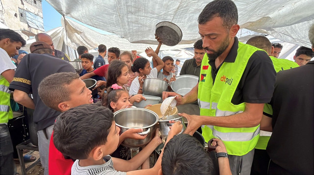 Relawan DT Peduli di Gaza Utara sedang membagikan makanan siap santap untuk pengungsi di wilayah Gaza Utara (Sumber : DT Peduli)
