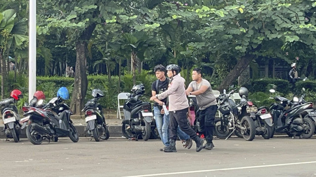 Petugas kepolisian mengamankan demonstran saat unjuk rasa supir truk tolak peraturan ODOL ke pemerintah di Jalan Merdeka Selatan, Jakarta, Rabu (2/7/2025). Foto: Rayyan Farhansyah/kumparan