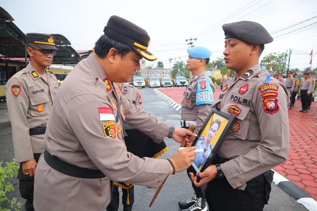 Kapolres Sintang, AKBP I Nyoman Budi Artawan mencoret poto Bripka Nuryadin yang telah menerima Pemberhentian Tidak Dengan Hormat (PTDH) sebagai anggota Polri. Foto: Dok Polres Sintang