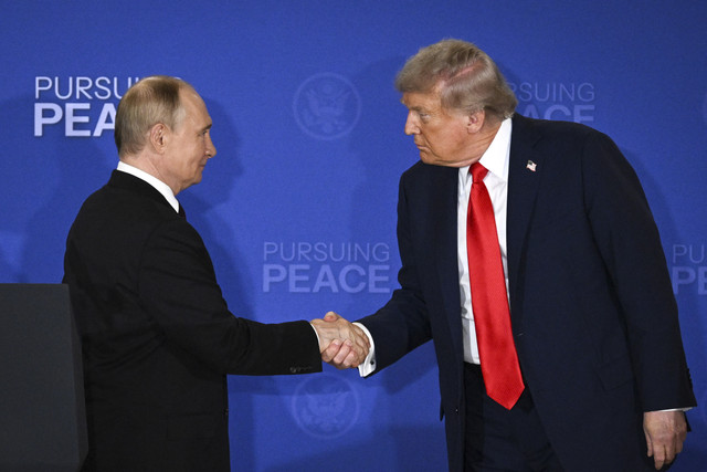 Presiden Amerika Serikat Donald Trump berjabat tangan dengan Presiden Rusia Vladimir Putin saat melakukan pertemuan terkait KTT AS-Rusia di Pangkalan Gabungan Elmendorf-Richardson, Anchorage, Alaska, Jumat (15/8/2025). Foto: Drew Angerer/AFP