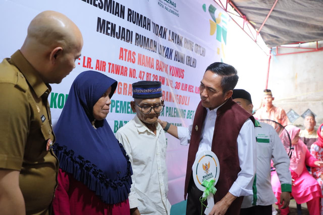 Wali Kota Palembang, Ratu Dewa, saat menyerahkan kunci rumah yang telah direnovasi kepada pemilik rumah, Yunus/Ist. 