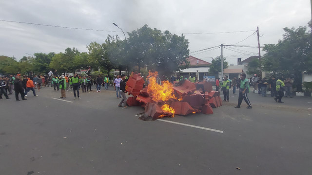 Sejumlah massa aksi membakar separator jalan di Solo, Jawa Tengah, Jumat (29/8/2025). Foto: kumparan