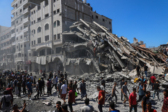 Warga Palestina memeriksa lokasi rumah yang dievakuasi setelah terkena serangan udara Israel di Kota Gaza, 12 September 2025.  Foto: REUTERS/Ebrahim Hajjaj