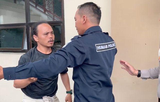 Momen saat personel Humas Polda Jambi menghalangi wartawan. Dok: Ist.