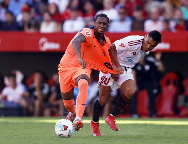 Alejandro Balde dari FC Barcelona beraksi bersama Alexis Sanchez dari Sevilla pada pertandingan Liga Spanyol antara Sevilla v FC Barcelona di Ramon Sanchez Pizjuan, Seville, Spanyol, Minggu (5/10/2025). Foto: Marcelo Del Pozo/REUTERS