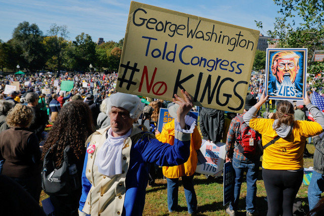 Seorang pria berpakaian seperti mantan Presiden AS George Washington mengikuti protes "No Kings" terhadap kebijakan Presiden AS Donald Trump di Boston, Massachusetts, Amerika Serikat, Sabtu (18/10/2025). Foto: Brian Snyder/REUTERS
