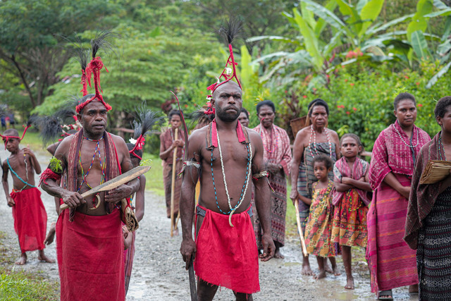 Sejumlah masyarakat adat berdiri untuk bersiap melakukan Tari Alen, tarian khas untuk menyambut para tamu yang datang ke Kampung Malasigi, Sorong, Papua Barat Daya. Foto: Iqbal Firdaus/kumparan