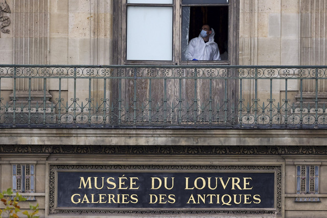Petugas forensik kepolisian memeriksa jendela yang dibobol dalam aksi perampokan di Museum Louvre, Paris, Prancis, Minggu (19/10/2025). Foto: Gonzalo Fuentes/Reuters