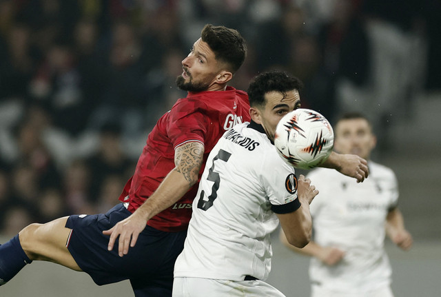 Pemain Lille Olivier Giroud berebut bola dengan pemain PAOK Loannis Michailidis dalam pertandingan Liga Europa musim 2025/2026 di Decathlon Arena Stade Pierre-Mauroy, Prancis, Kamis (23/10/2025). Foto: Benoit Tessier/Reuters