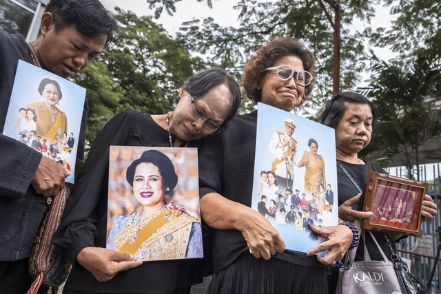 Seorang warga memegang bingkai foto Ratu Sirikit dari Thailand saat berkumpul di depan Rumah Sakit Chulalongkorn, Bangkok, Thailand, Sabtu (25/10/2025). Foto: CHANAKARN LAOSARAKHAM/AFP