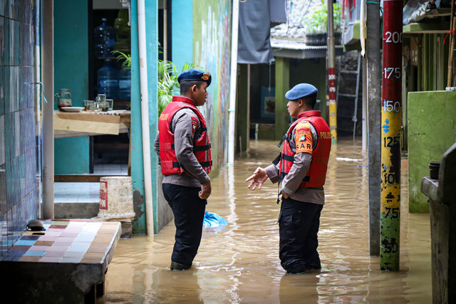 Petugas berjaga saat banjir di kawasan Kebon Pala, Kecamatan Jatinegara, Jakarta Timur, Selasa (28/10/2025). Foto: Iqbal Firdaus/kumparan