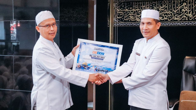 Simbolis Penyerahan Donasi Wakaf untuk Palestina oleh Bendahara YDT, Ujang Karim kepada Bendahara YDTP, Cucu Hidayat (Sumber : DT Peduli)