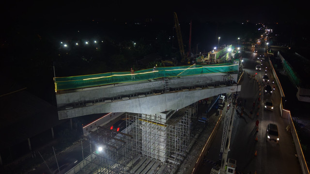 Proses pengerjaan konstruksi dan persiapan pemutaran pier head (lengan beton) menggunakan teknologi Sosrobahu pada malam hari di Proyek Tol Jogja-Solo, Ringroad Utara. Foto: Dok. Adhi Karya