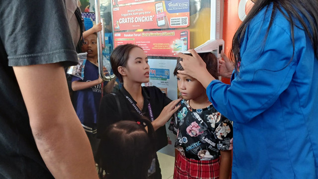 Pengukuran tinggi badan anak di kegiatan edukasi pemenuhan zat besi oleh Alfamidi Manado.