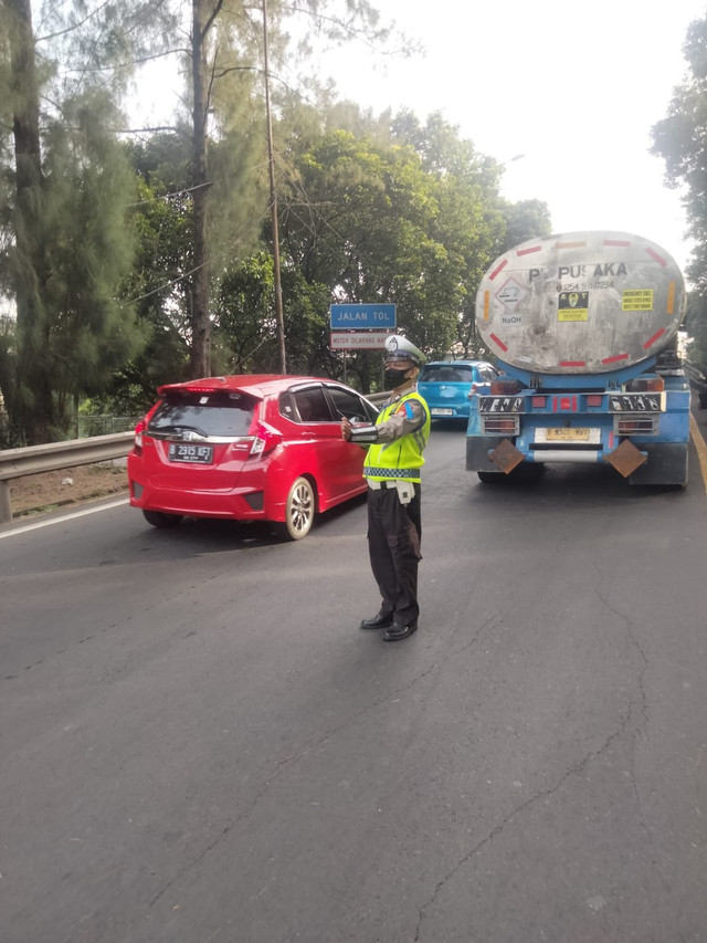 Polisi tengah mengatur kepadatan lalu lintas akibat truk tangki mengalami gangguan di Tol Dalam Kota (Cawang Interchange) arah Tol Cikampek, Rabu (26/11/2025). Foto: X/ @TMCPoldaMetro