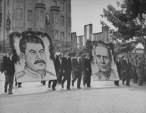 Lukisan wajah Pemimpin Uni Soviet Joseph Stalin (kiri) dan Pemimpin Yugoslavia Josip Broz Tito (kanan) dalam perayaan Hari Buruh Internasional (May Day) di Beograd, Yugoslavia (kini Serbia) pada tahun 1946. Pada periode ini hubungan Tito dan Stalin masih sangat dekat, sehingga wajah Stalin diarak bersamaan dengan wajah Tito dalam perayaan May Day. Sumber Poto: commons.wikimedia.org (saat penulis ambil poto ini di situs wikimedia, dijelaskan bahwa poto ini sudah jadi public domain dan hak ciptanya sudah habis). 