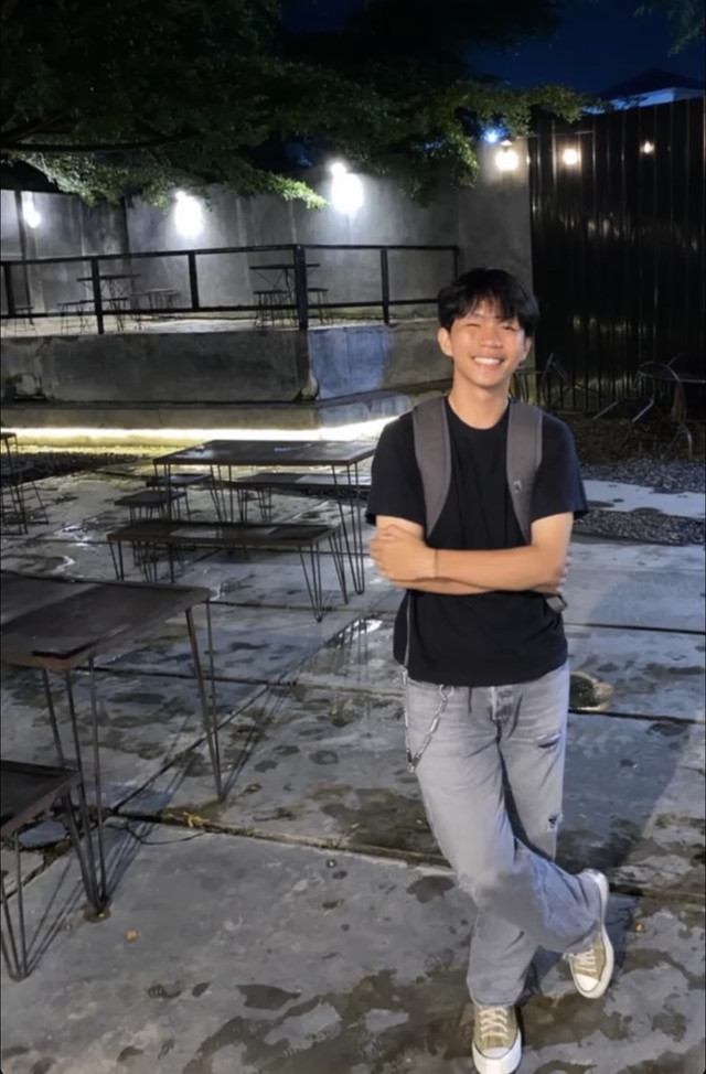 Sumber foto: Dokumentasi pribadi. Seorang pria berpose di sebuah kafe malam hari. Berbagi foto aktivitas sehari-hari menjadi salah satu cara kita menjaga kedekatan dalam hubungan yang sepenuhnya dijalani lewat media sosial.