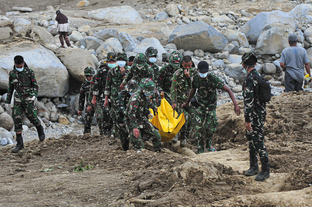 Prajurit Batalyon TP 897/Singalang menggotong jenazah korban meninggal akibat banjir bandang di Nagari Salareh Aia Timur, Palembayan, Agam, Sumatera Barat, Senin (1/12/2025). Foto: Wahdi Septiawan/ANTARA FOTO