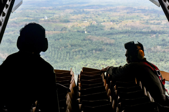 Prajurit TNI AU Skadron Udara 2 bersiap mendistribusikan helibox  berisi bantuan untuk pengungsi banjir menggunakan metode Container Delivery Sistem dengan pesawat CN 295 di Kecamatan Kuala Simpang, Kabupaten Aceh Tamiang, Aceh, Selasa (2/12/2025). Foto: Fakhri Hermansyah/ANTARA FOTO