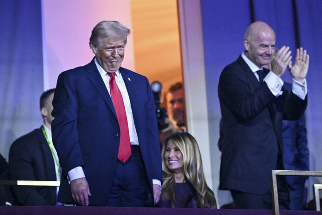 Presiden Amerika Serikat Donald Trump didampingi istri Lady Melania Trump dan Presiden FIFA Gianni Infantino saat pengundian Piala Dunia 2026 di Washington DC, Amerika Serikat, Jumat (5/12/2025). Foto: Mandel Ngan/AFP