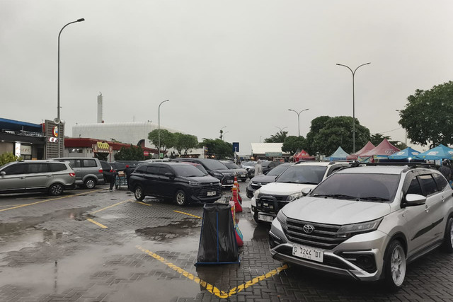 Parkiran rest area KM 166 Tol Cipali diguyur hujan dan terpantau padat, Jumat (26/12/2025). Foto: Dok. kumparan