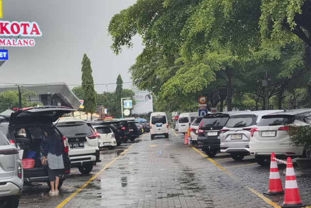 Parkiran rest area KM 166 Tol Cipali diguyur hujan dan terpantau padat, Jumat (26/12/2025). Foto: Dok. kumparan
