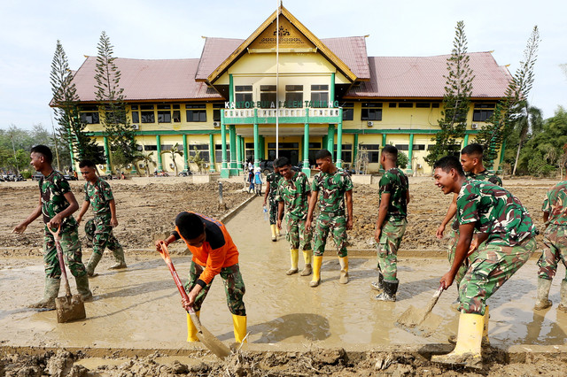 Prajurit TNI membersihkan lumpur di halaman Kantor Bupati Aceh Tamiang, Aceh, Senin (29/12/2025). Foto: ANTARA FOTO/Irwansyah Putra