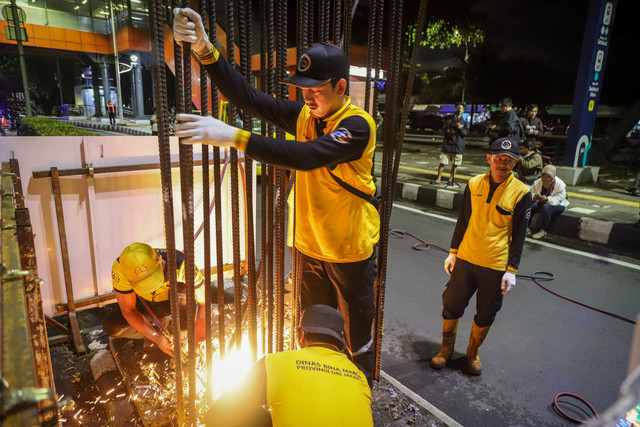 Petugas Dinas Bina Marga memotong satu tiang monorel di Jalan HR Rasuna Said, Jakarta Selatan pada Rabu (14/1) malam sebagai tahap awal. Foto: Iqbal Firdaus/kumparan