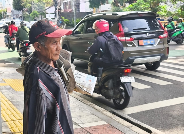 Firman (70) penjual koran di sekitar perempatan Jalan Hos. Cokroaminoto No. 70, Menteng, Jakarta Pusat, Senin (19/1). Foto: Jeni Ritanti/kumparan