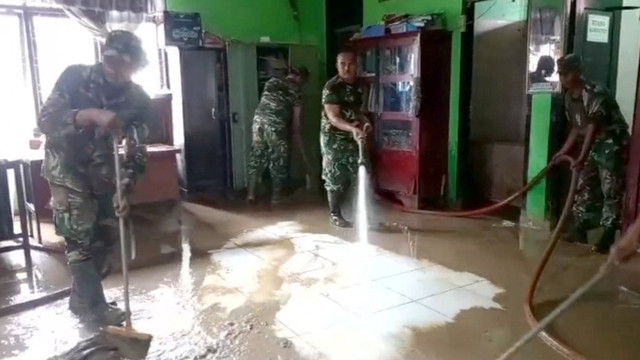 Prajurit TNI AD membersihkan lumpur yang terbawa banjir di SD Muhammadiyah Meureudu, Aceh. Foto: Bakom RI