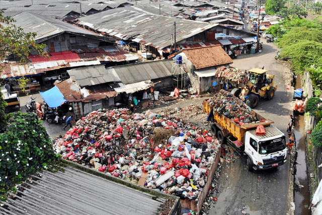 Foto udara petugas Dinas Lingkungan Hidup Kota Depok menggunakan alat berat untuk mengangkut sampah dari tempat pembuangan sementara di Kota Depok, Jawa Barat, Kamis (5/2/2026). Foto: Yulius Satria Wijaya/ANTARA FOTO
